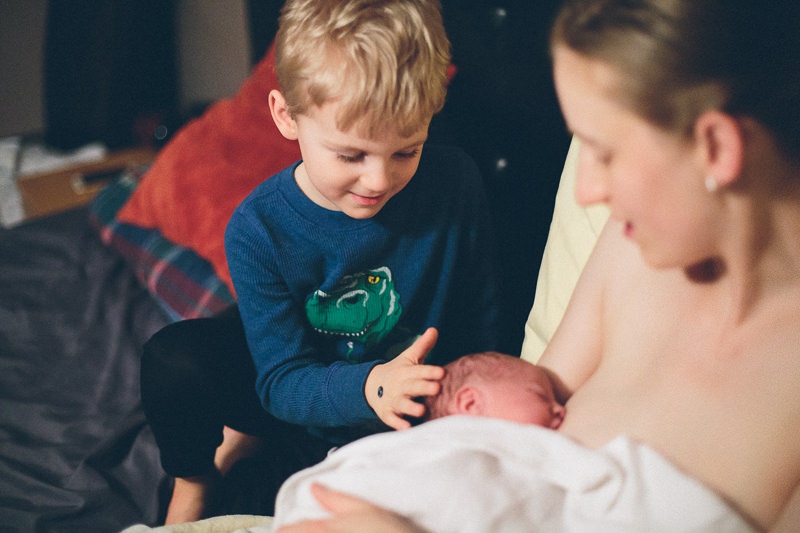 big brother checking out baby sister