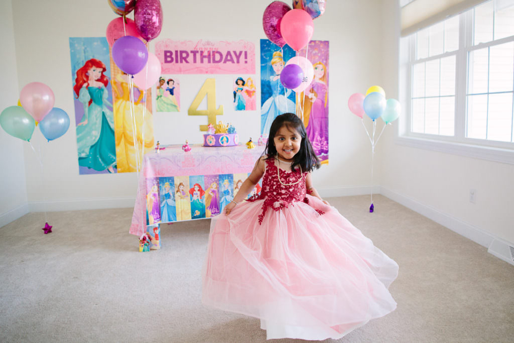 dark hair girl spinning in princess dress at party
