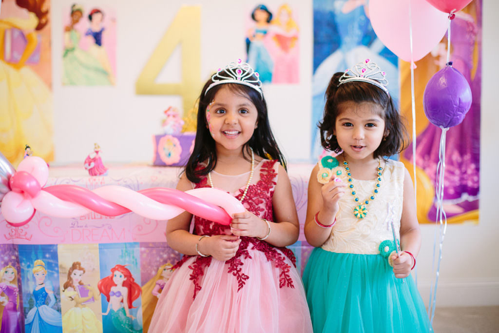 little girls surrounded by princess decorations at party