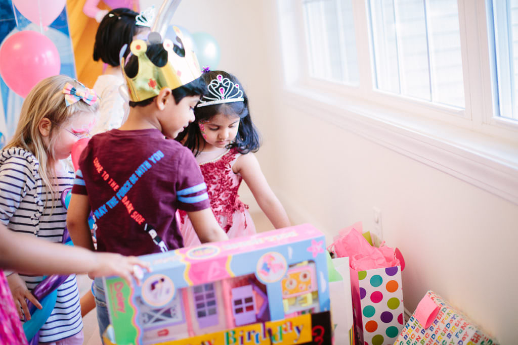 birthday girl showing guests her presents