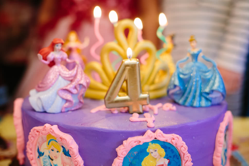 number 4 candle lit on birthday cake