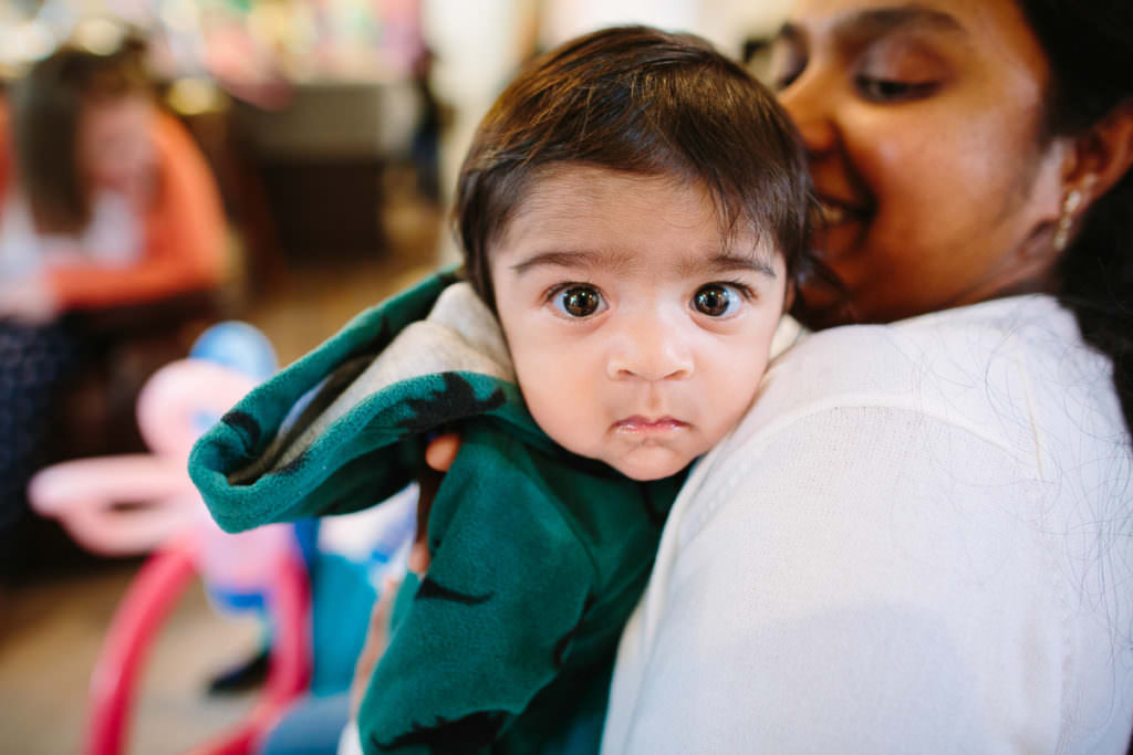 brown eyed baby with green sweater