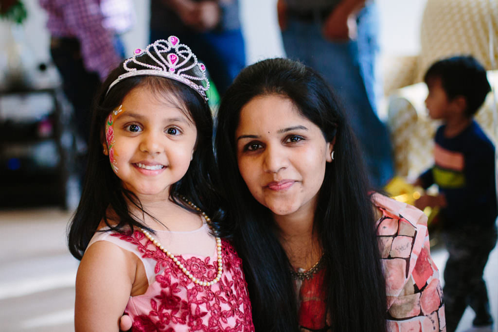birthday girl wearing crown with dark haired mom