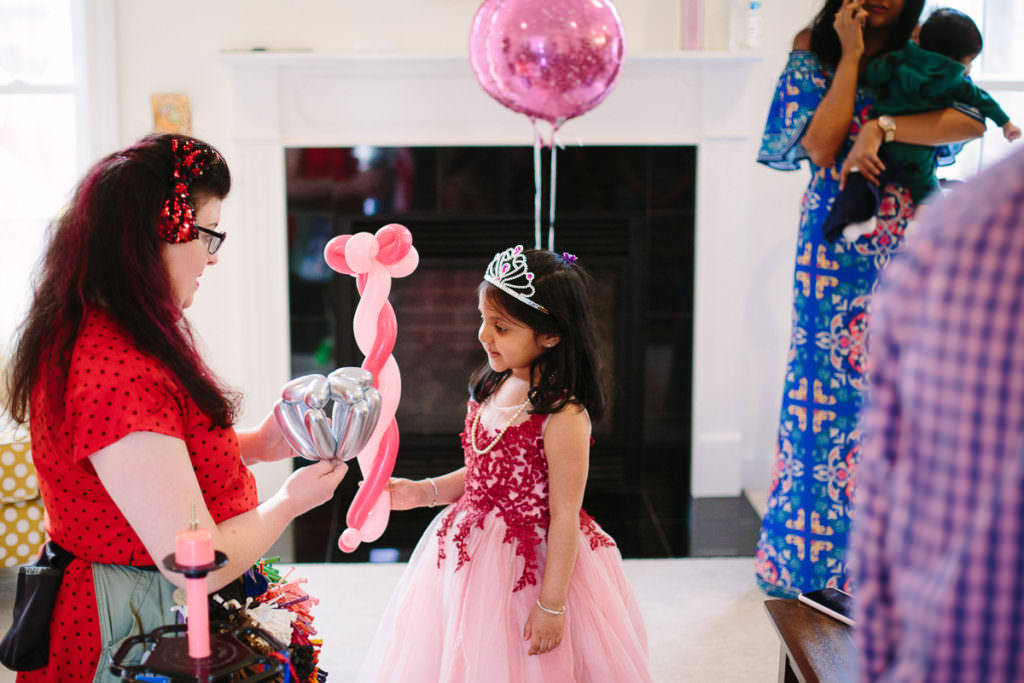 little girl holding her balloon wand