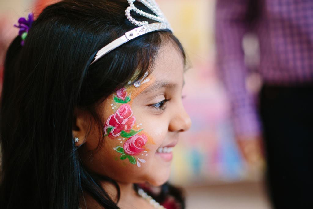 rose and sparkle face paint and dark haired girl