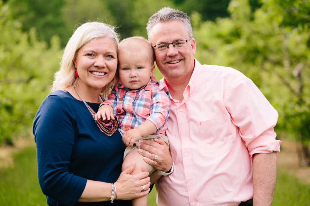 grandma and grandpa holding first grandson