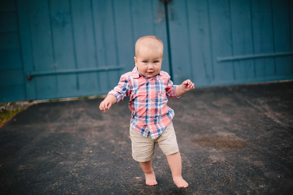 toddler boy wearing plaid shirt walking