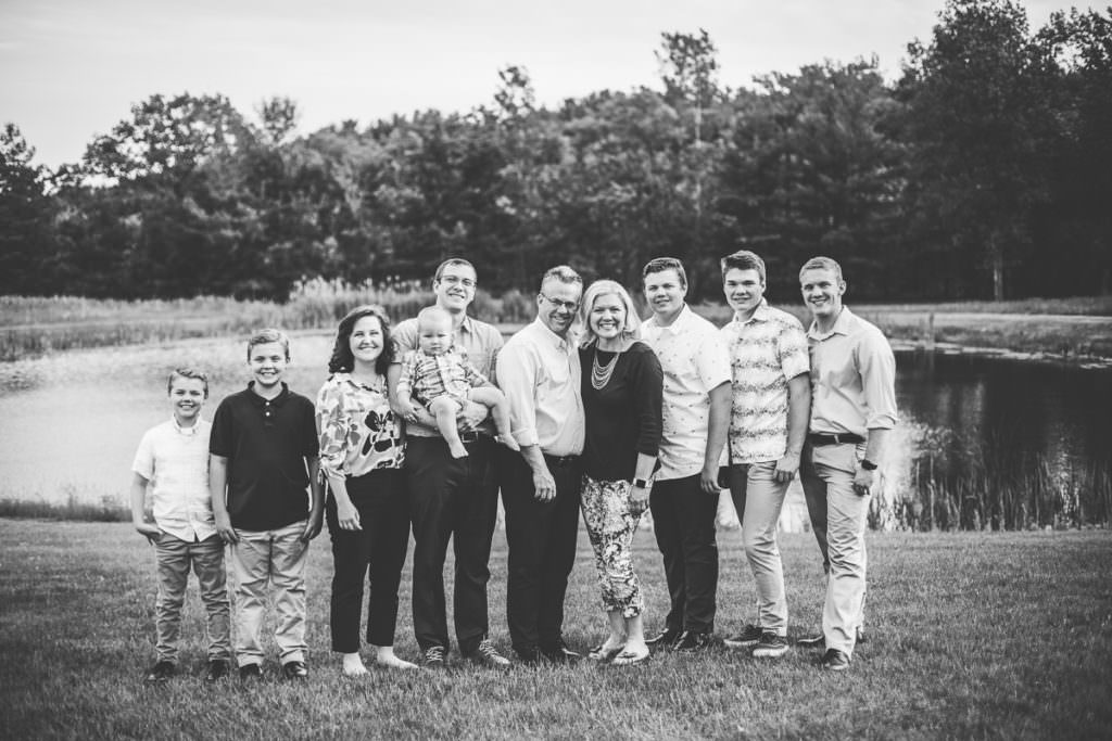family of 10 in front of pond at focastle farm