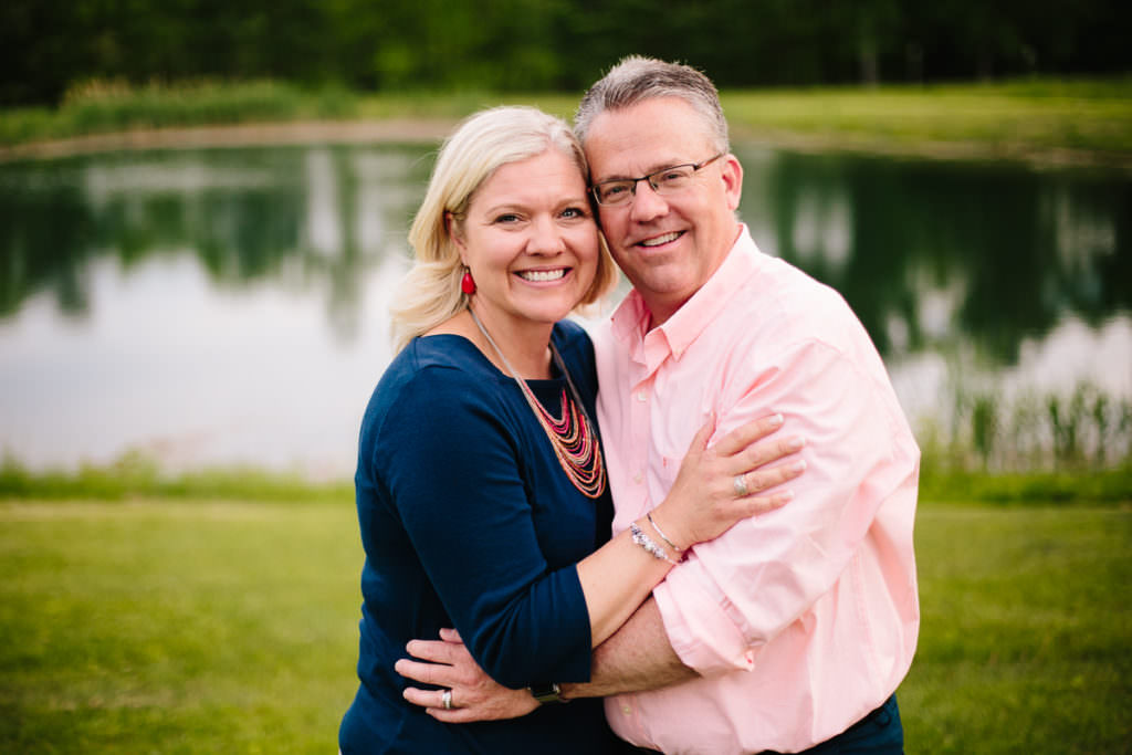 man and woman hugging by pond