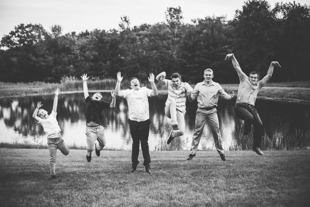 six brothers jumping by pond