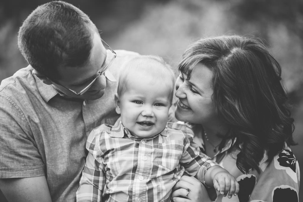 mom and dad looking at baby boy fo'castle orchard