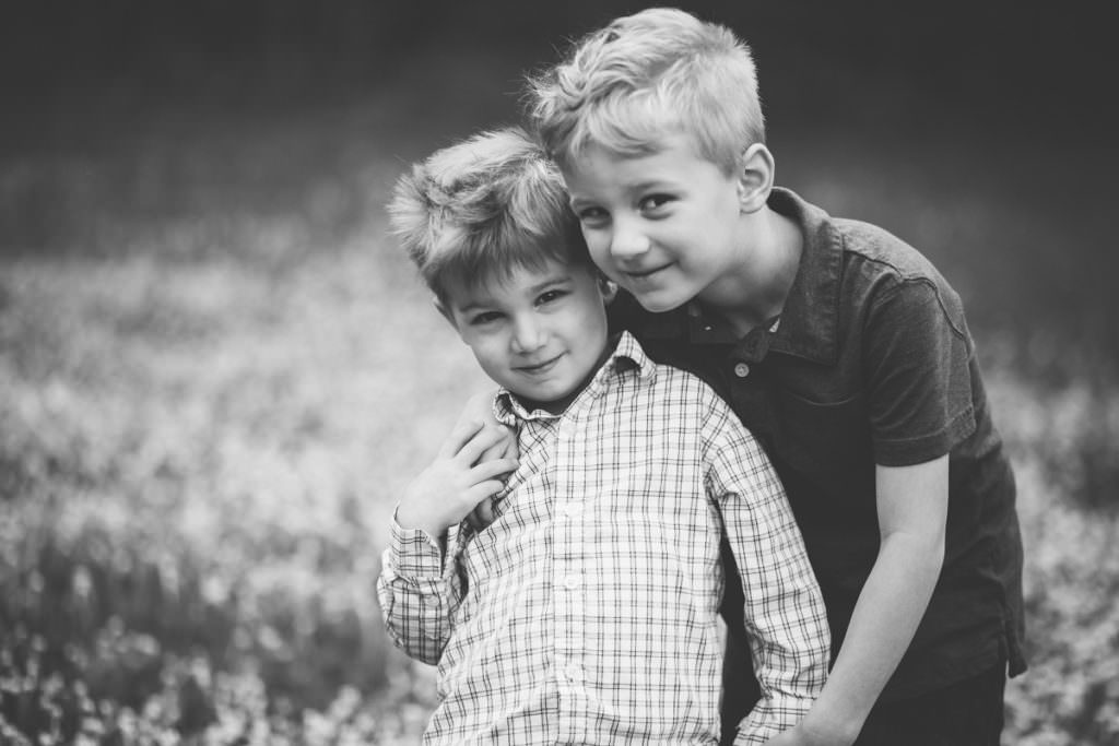 brothers standing cheek to cheek