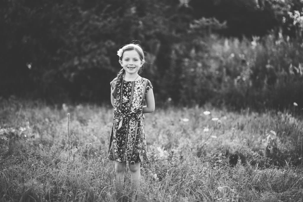 young girl standing in a field