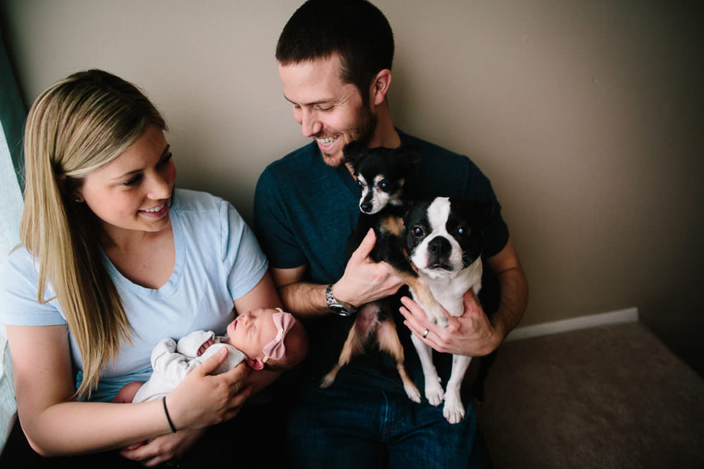 man holding 2 dogs woman holding baby girl