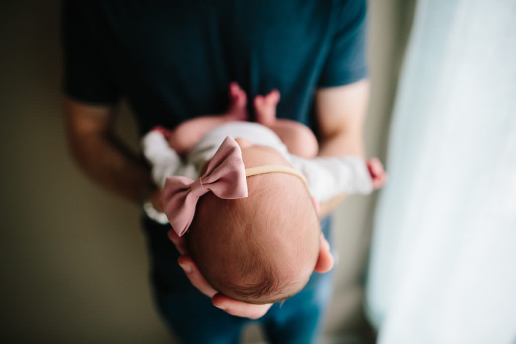 closeup picture of baby head and pink bow