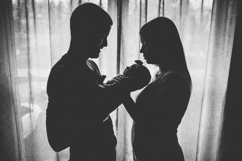 silhouette man woman and their baby