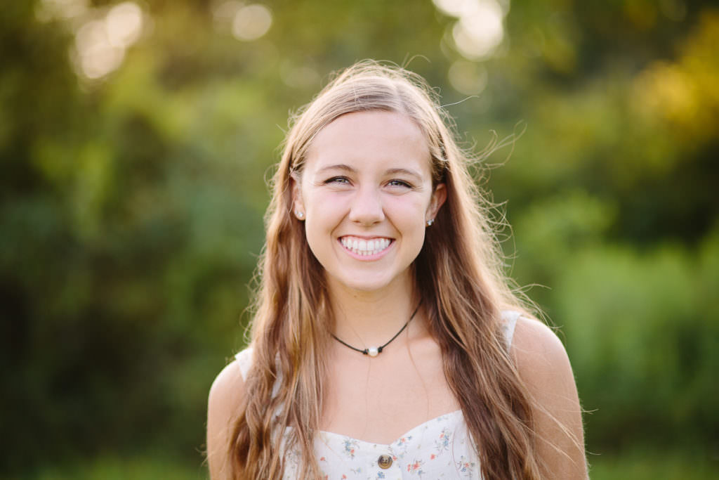 woman with long brown hair in field