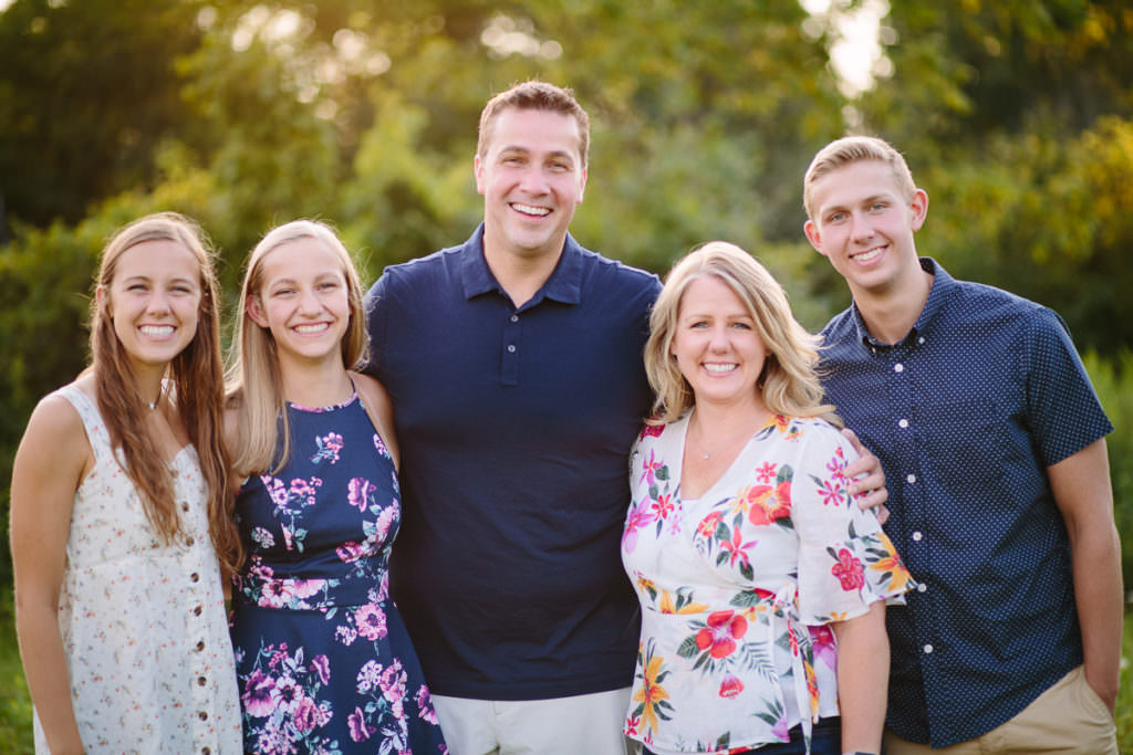 mom and daughters in flower dresses dad and son in blue