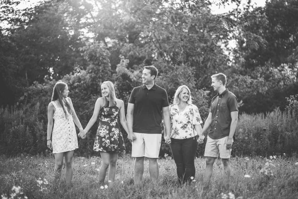 family of five laughing and talking in garnsey park