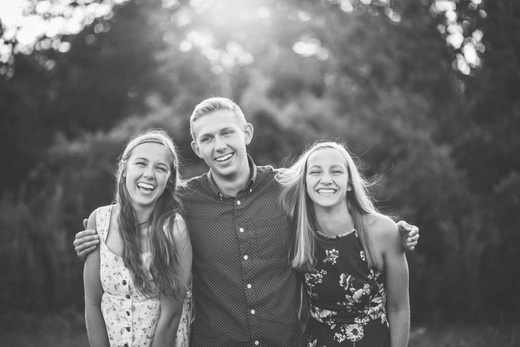 three siblings laughing