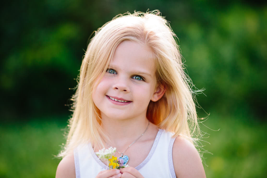blond hair girl holding flower
