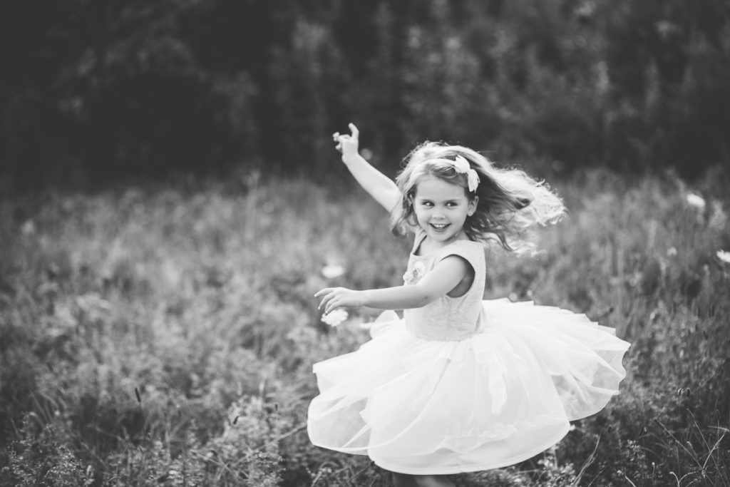 little girl twirling and smiling