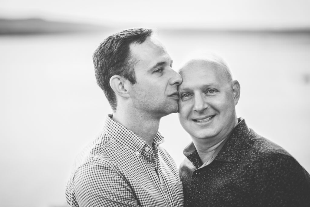 man kissing husband on the head