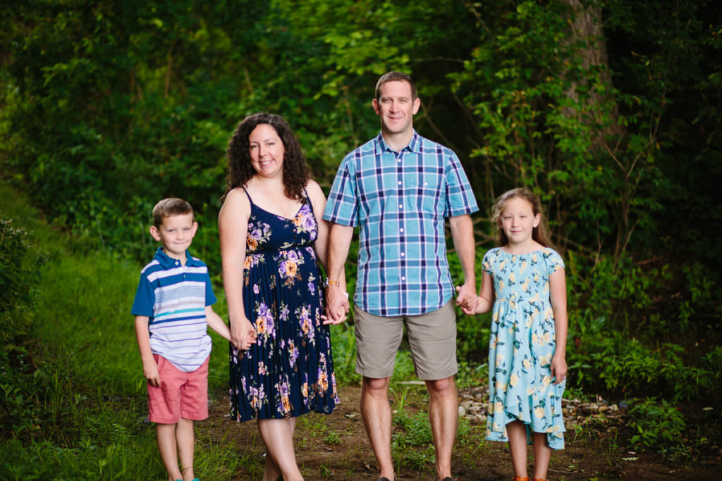 mom and dad holding hands with two kids