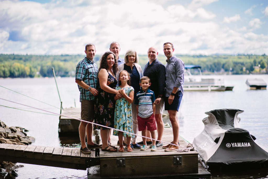 family standing on dock in lake sacandaga