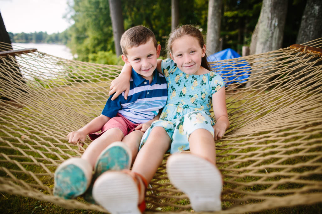 brother and sister sitting in hammock