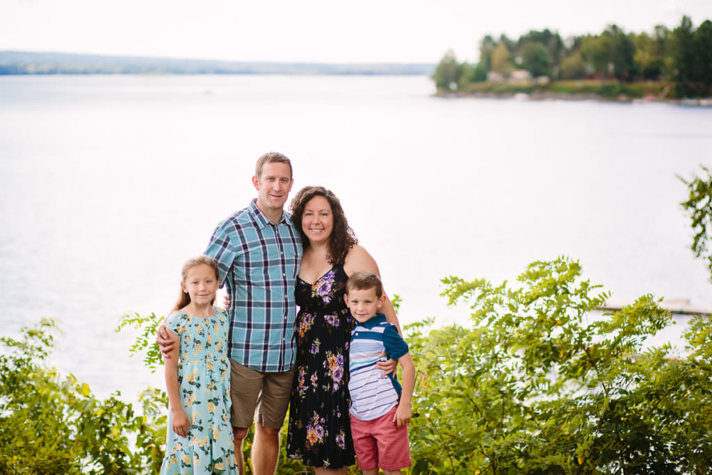 mom dad boy and girl standing by lake sacandaga