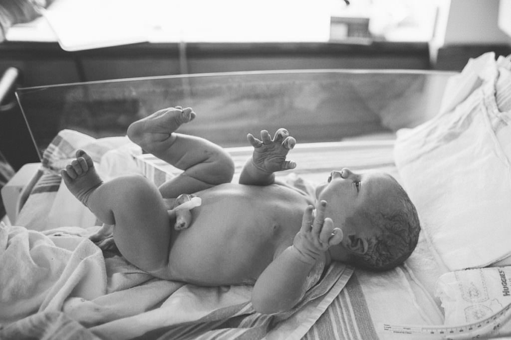 newborn baby in bassinet after hospital birth