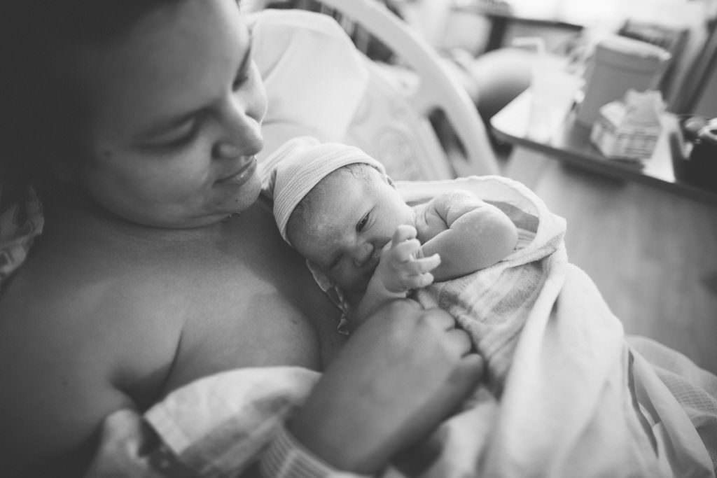 mom holding baby after hospital birth