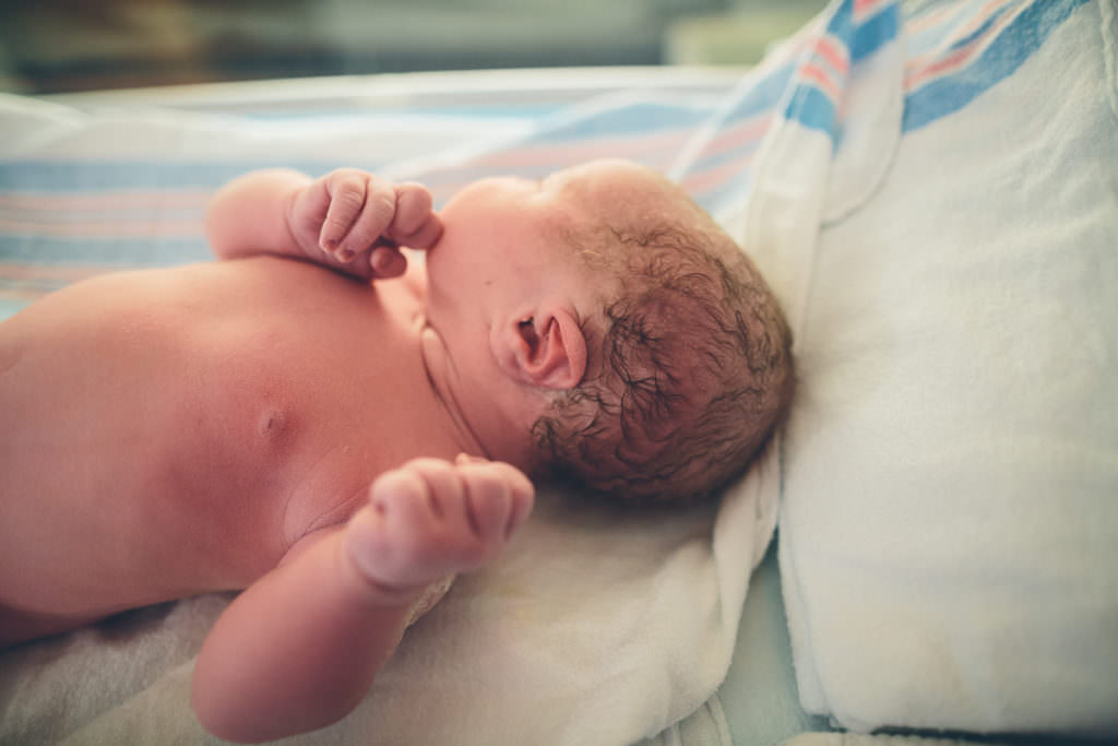 newborn baby looking away