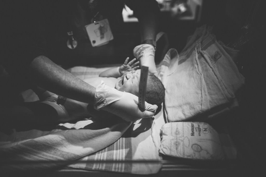 baby girl getting head measured after hospital birth