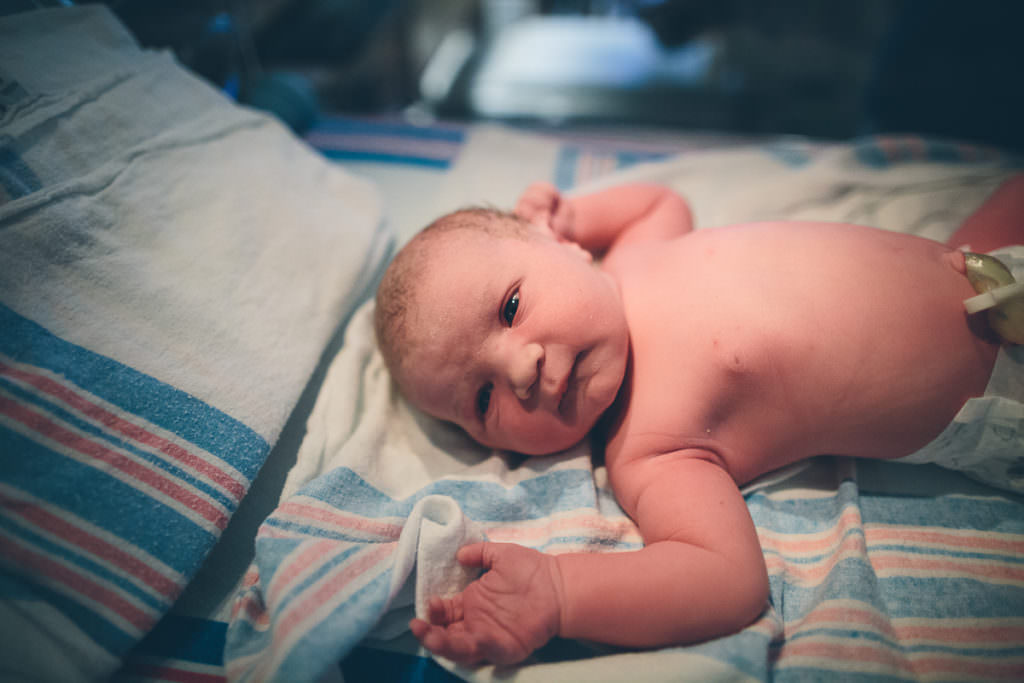 newborn baby girl in hospital bassinet