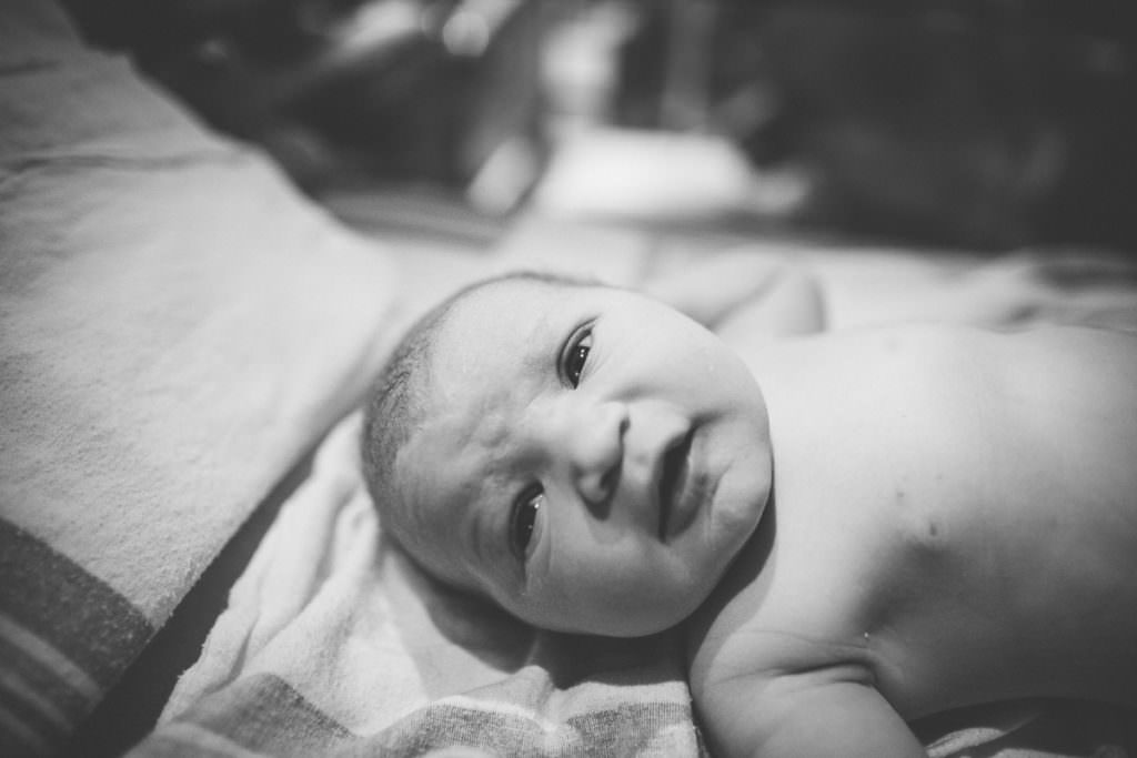 black and white picture of newborn baby girl after birth