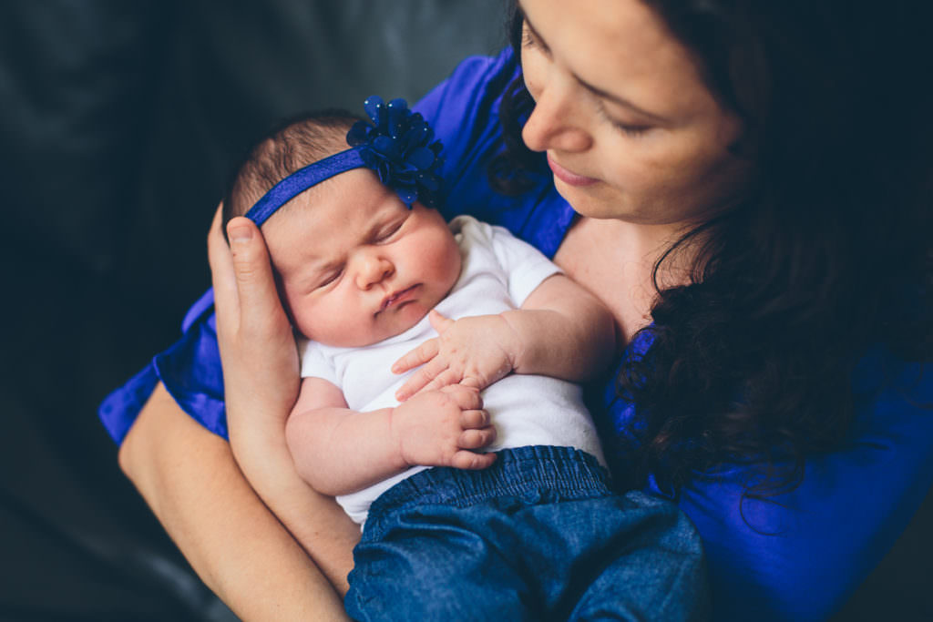 mom holding newborn baby girl