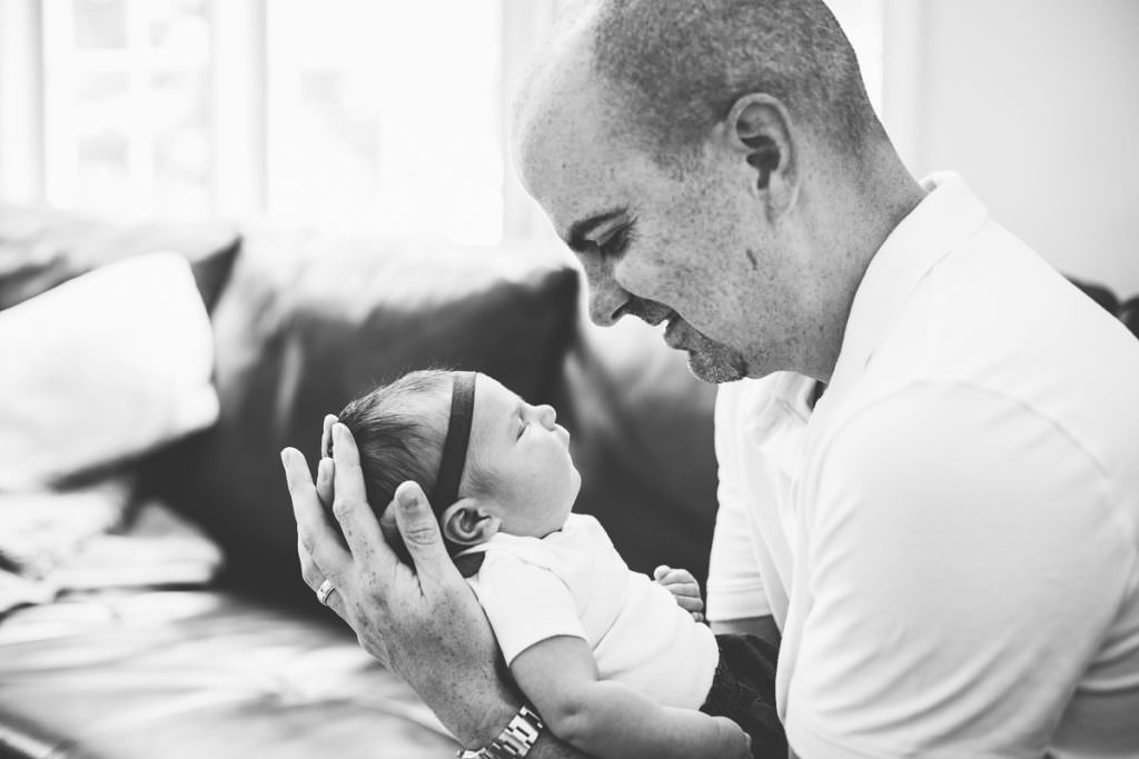 profiles of dad and newborn daughter
