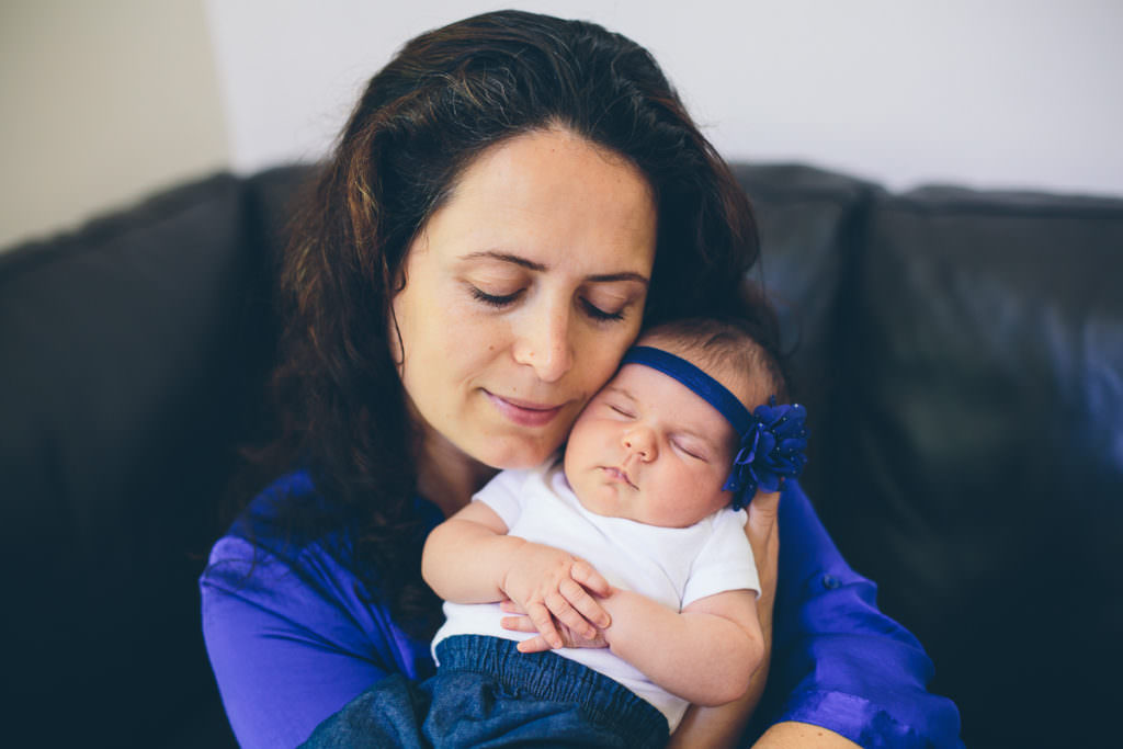 mom eyes closed holding sleeping baby