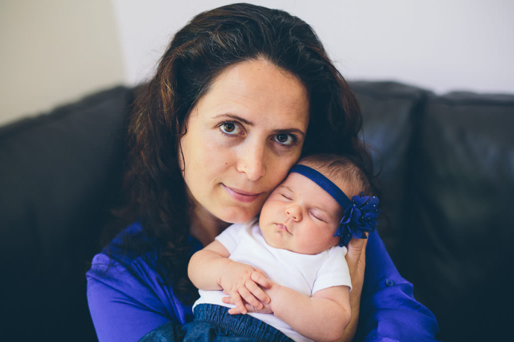 mom holding baby girl at home in niskayuna