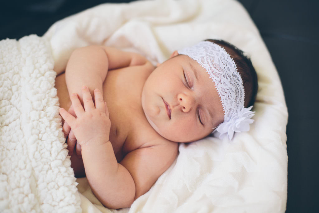 white flower headband on newborn baby girl