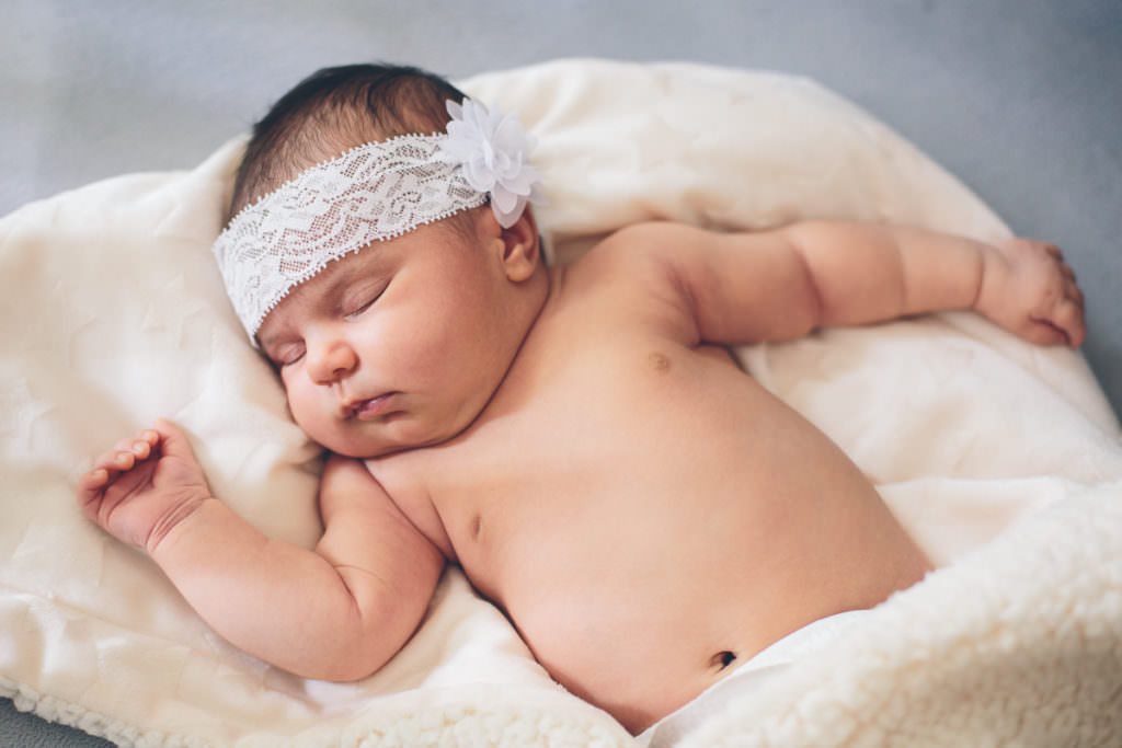 newborn baby girl sleeping in her crib
