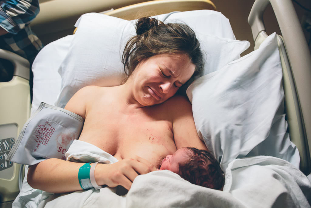 mom getting emotional after getting her vbac and holding her newborn