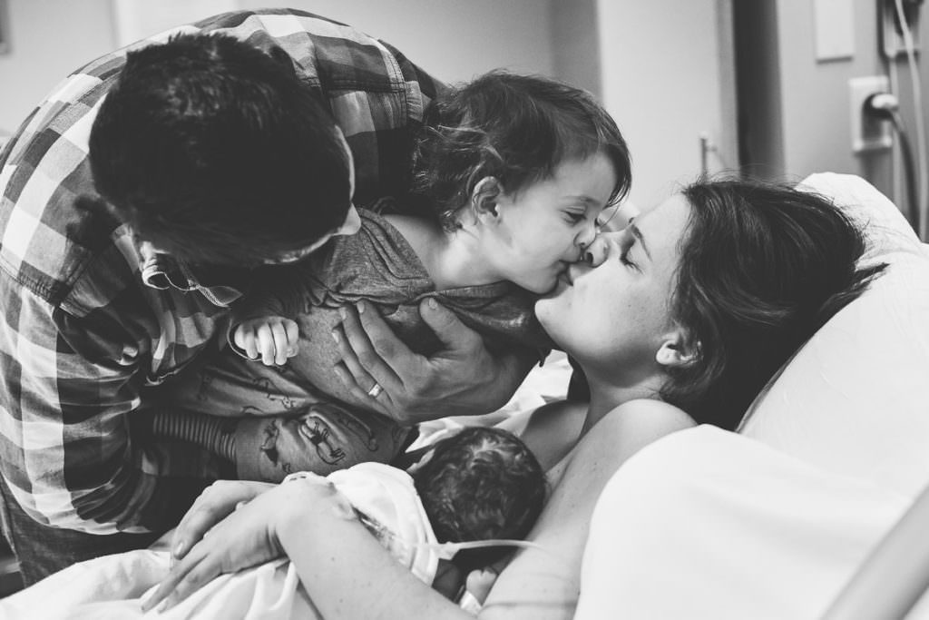 big brother gives mom a kiss