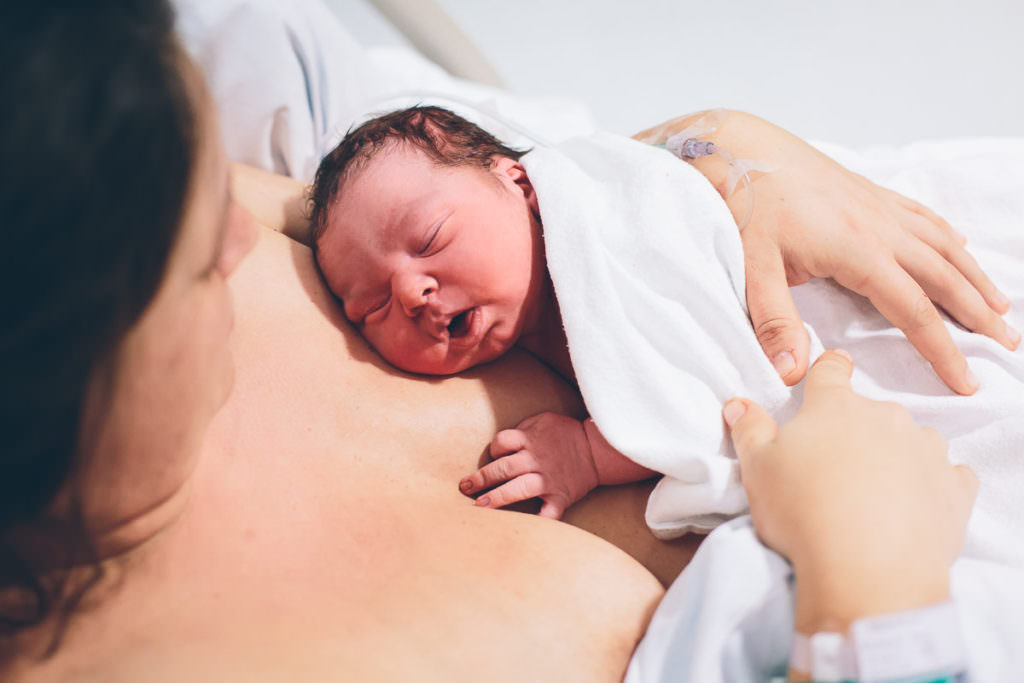sleeping newborn on moms chest