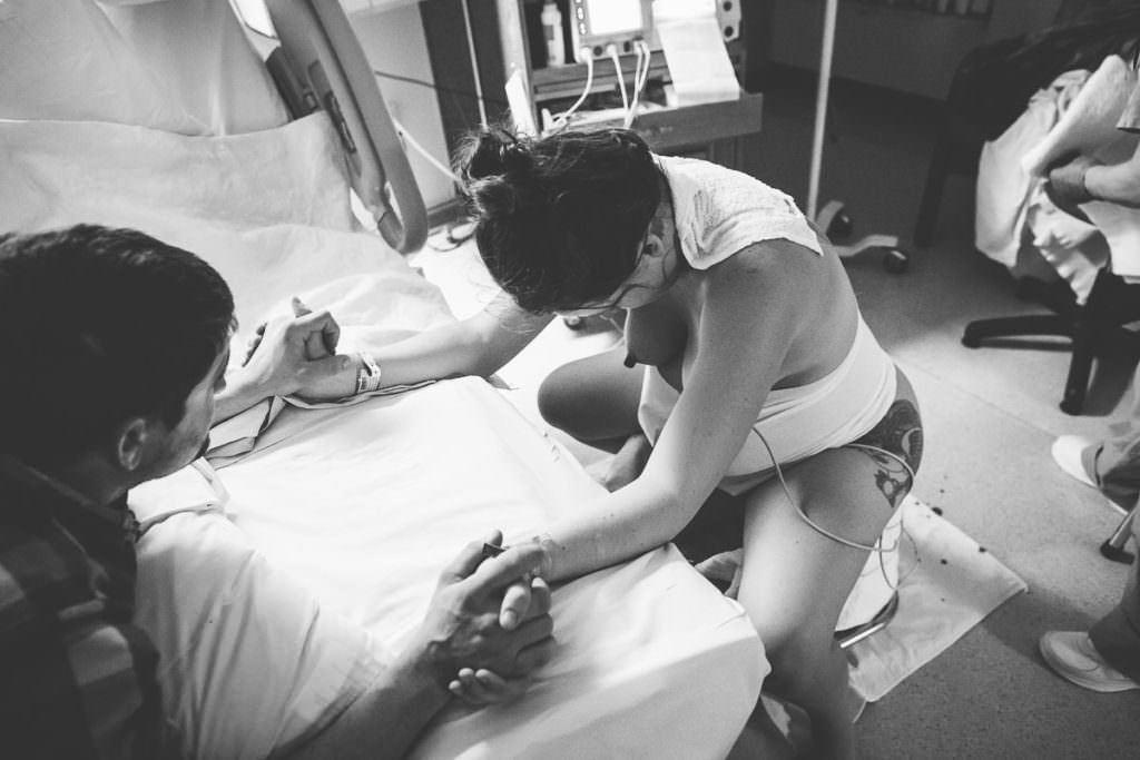 mom focused and calm gearing up for next contraction on birthing stool