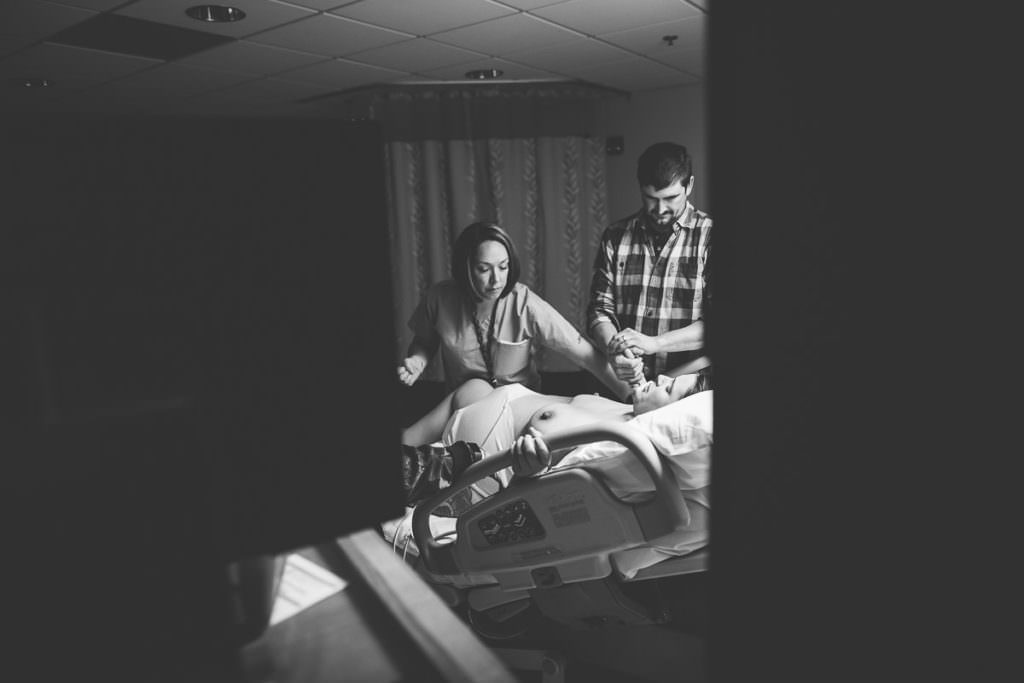 midwife and father helping mom during labor
