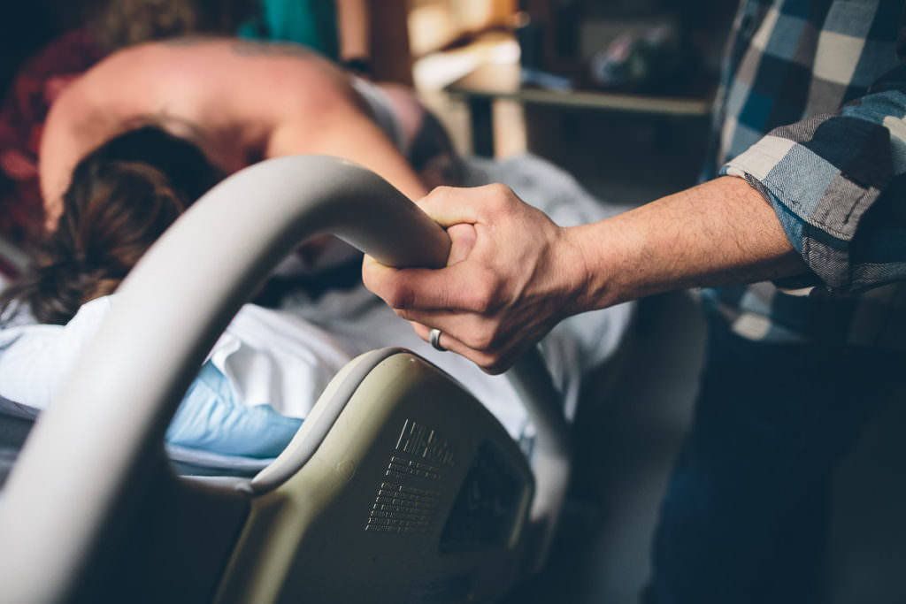holding the bed rail during labor