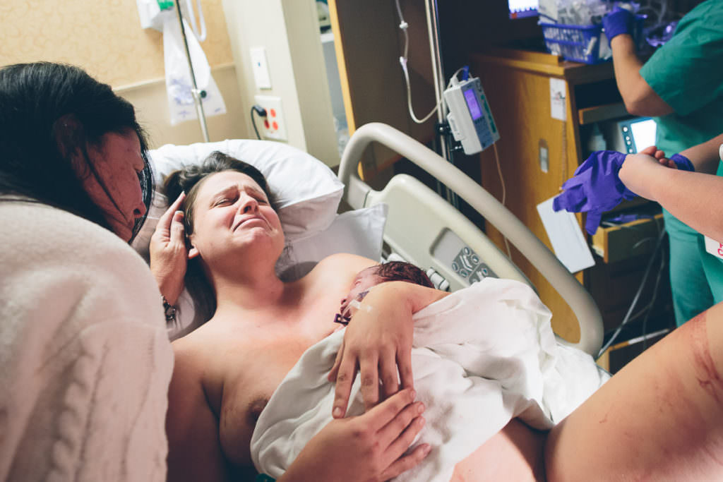 mom gets emotional when her mom comes over to see the new baby